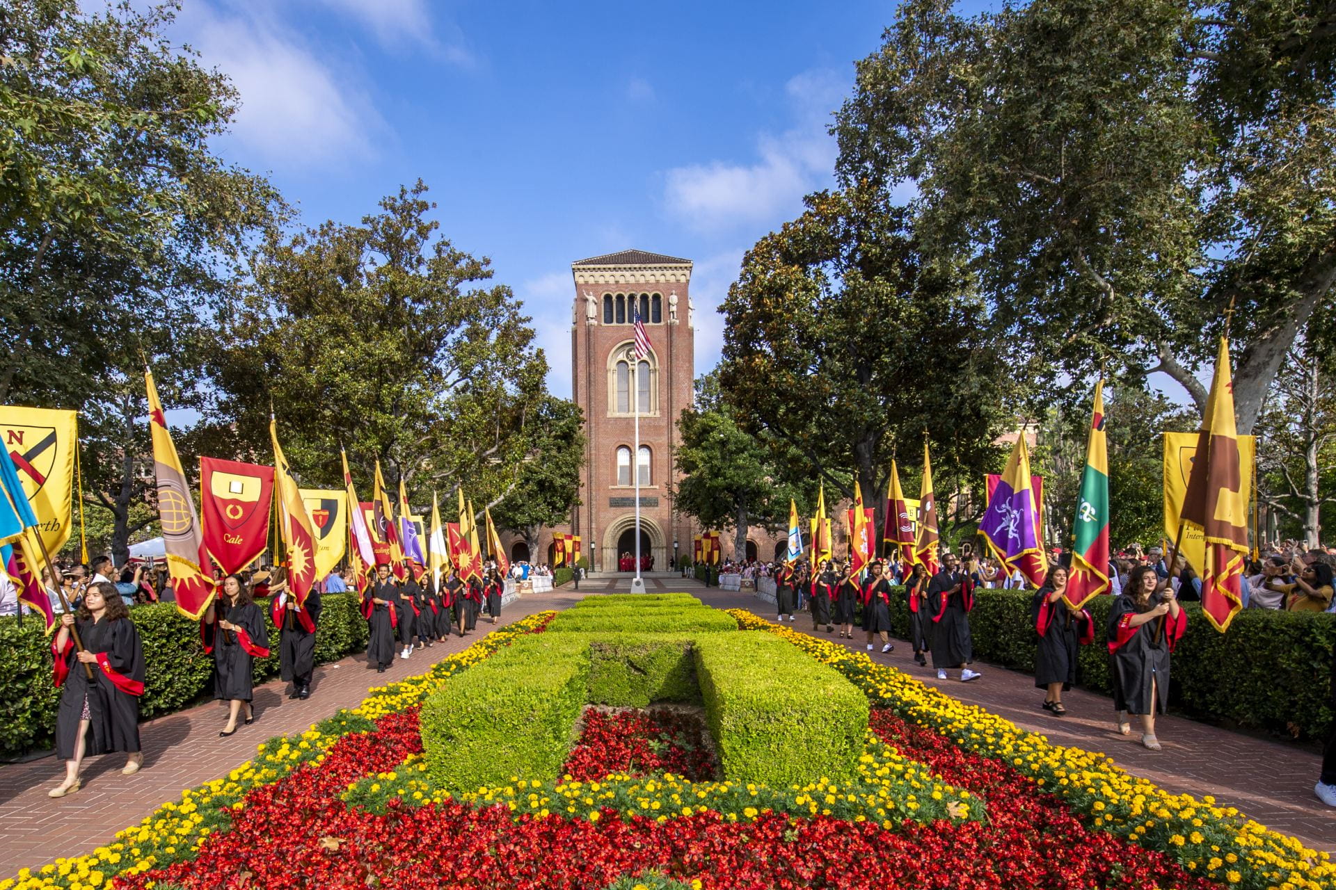 Flag bearers march into Alumni Park during new student Convocation, August 22, 2019. (Photo/Gus Ruelas)